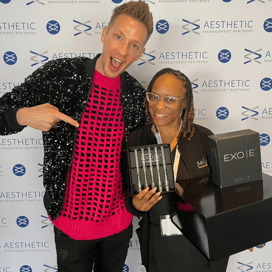 ToxJosh celebrates with a practitioner who won a grand prize at one of aesthetic management partners' elevate your aesthetic practice event